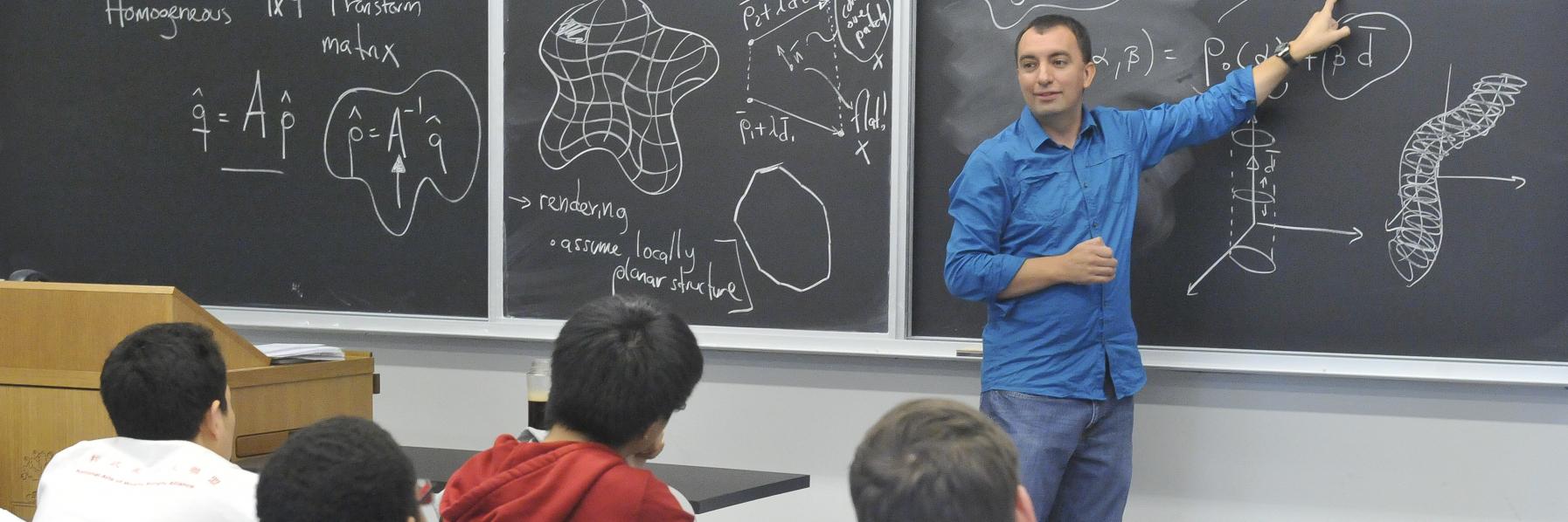 Professor teaching at chalkboard