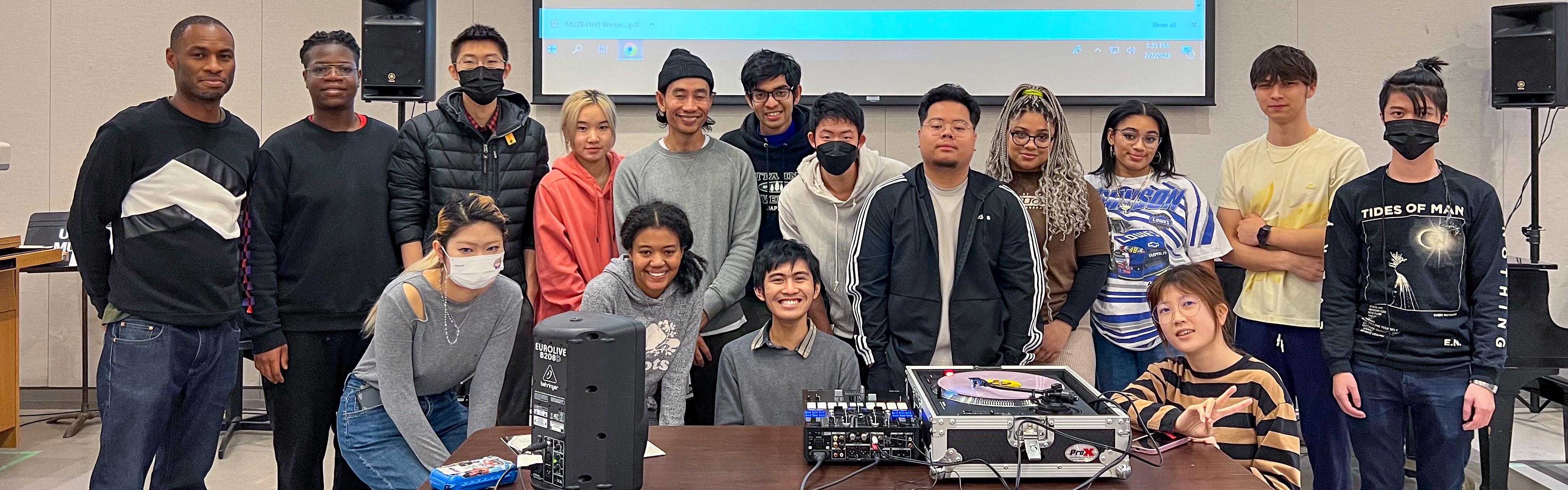 Music and culture students with equipment in front of a screen