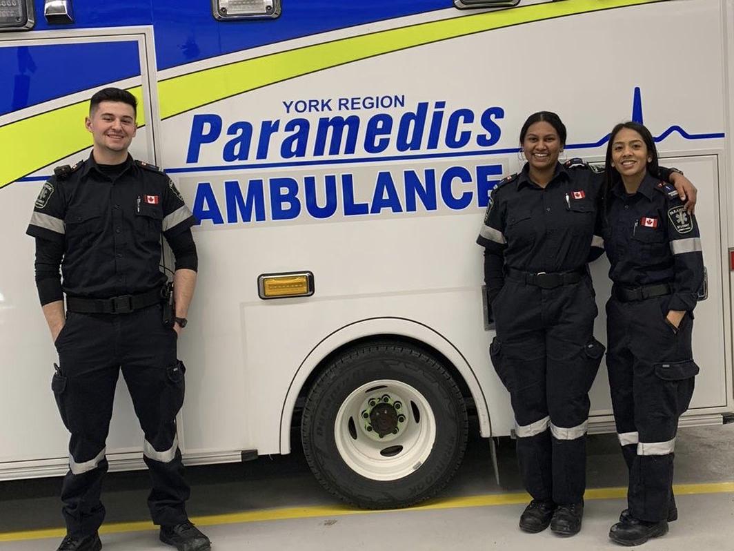 students in front of paramedic ambulance 