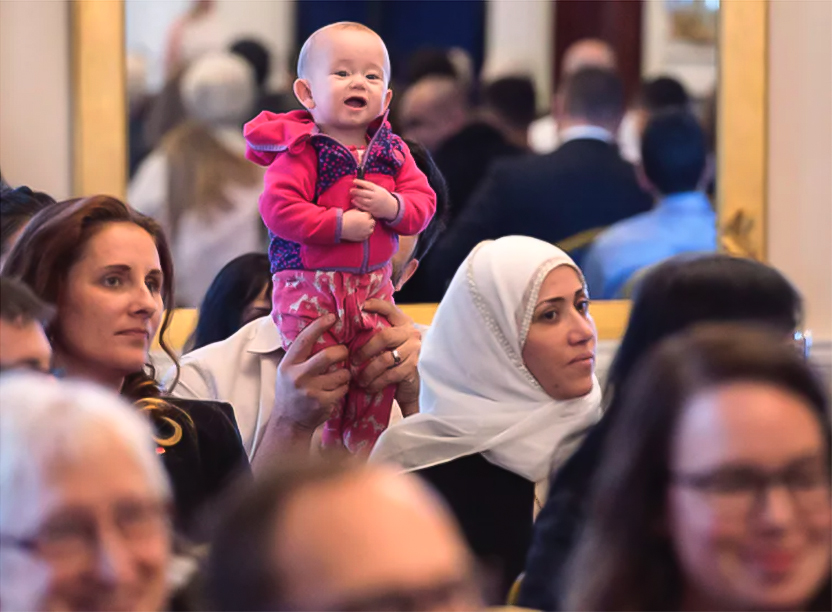 A child looks on at a citizenship ceremony 