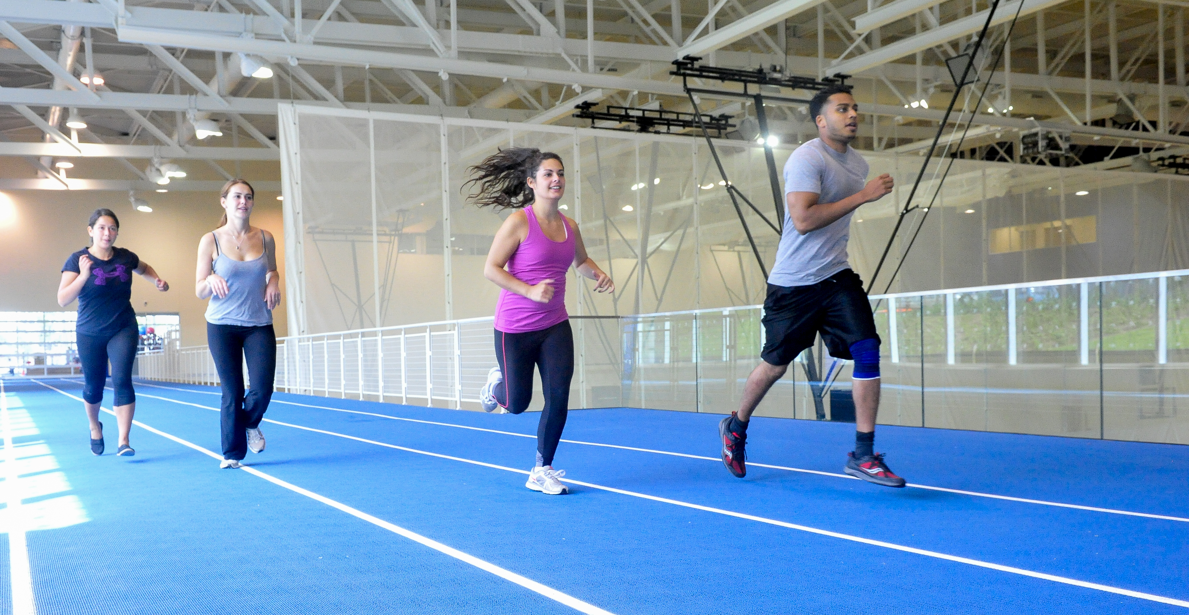 Students running on track in Toronto Pan Am Sports Centre.