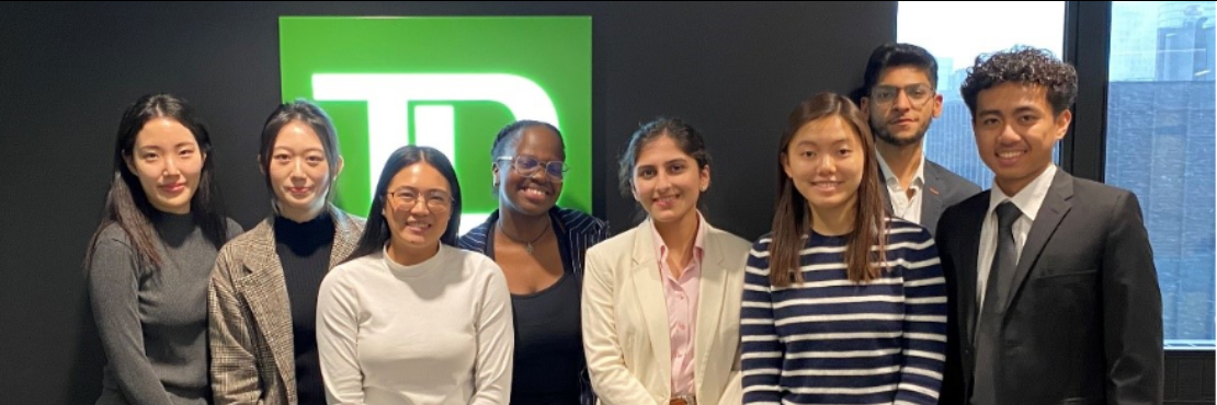 bunch of people in formal outfits smiling at the TD office