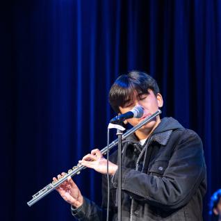 One student playing the flute in the group "VxD"