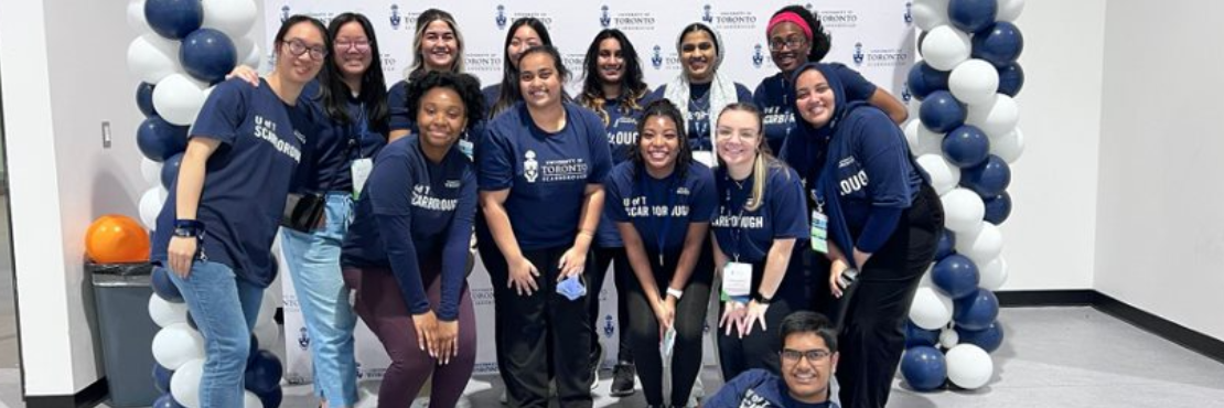 Group of Student Recruitment Assistants in front of UTSC backdrop