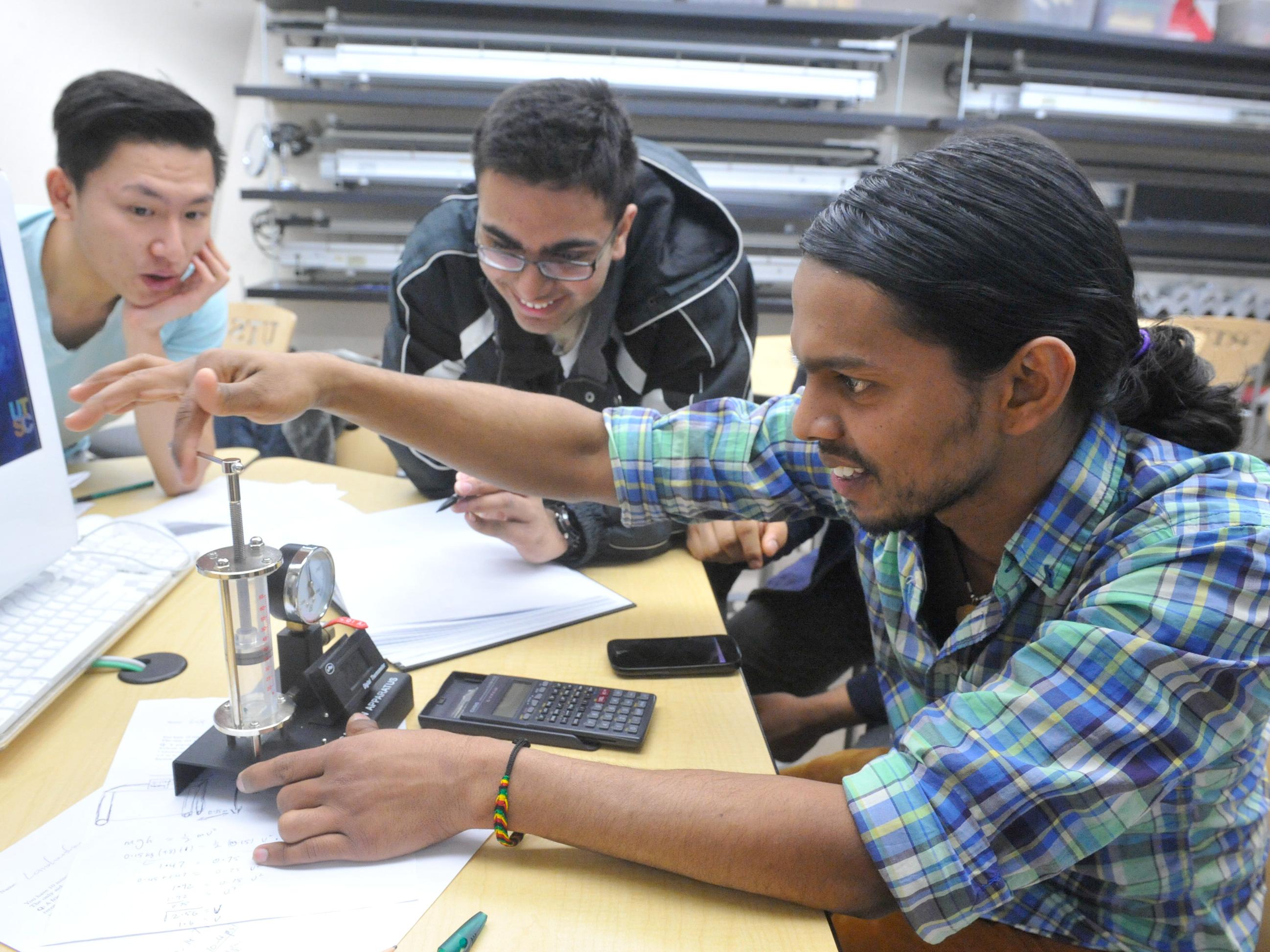 Students in a lab conducting a physics experiment