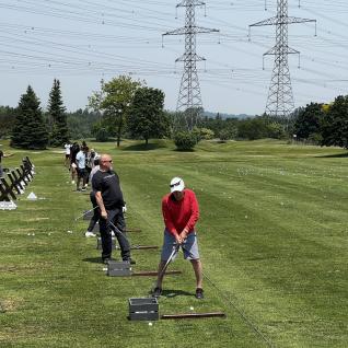 people practicing their swing at learn to golf
