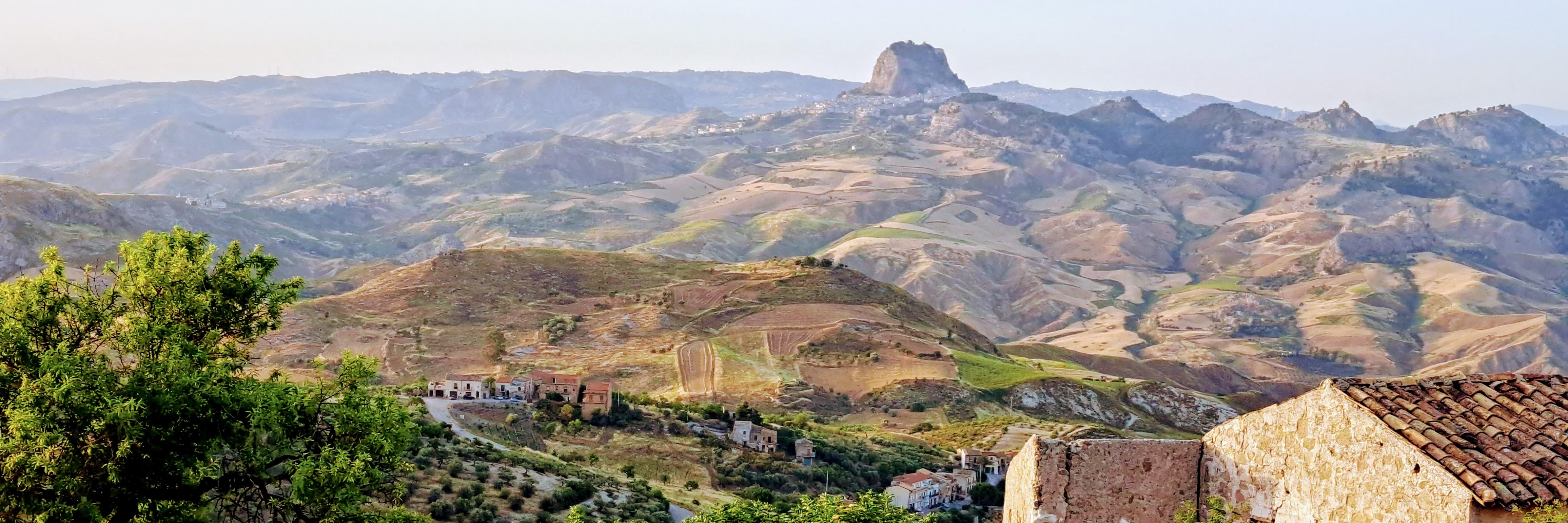 The Sardinian countryside on a bright summer's day with a small village and low rolling hills