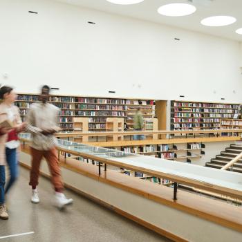 Blurred image of students walking in a library