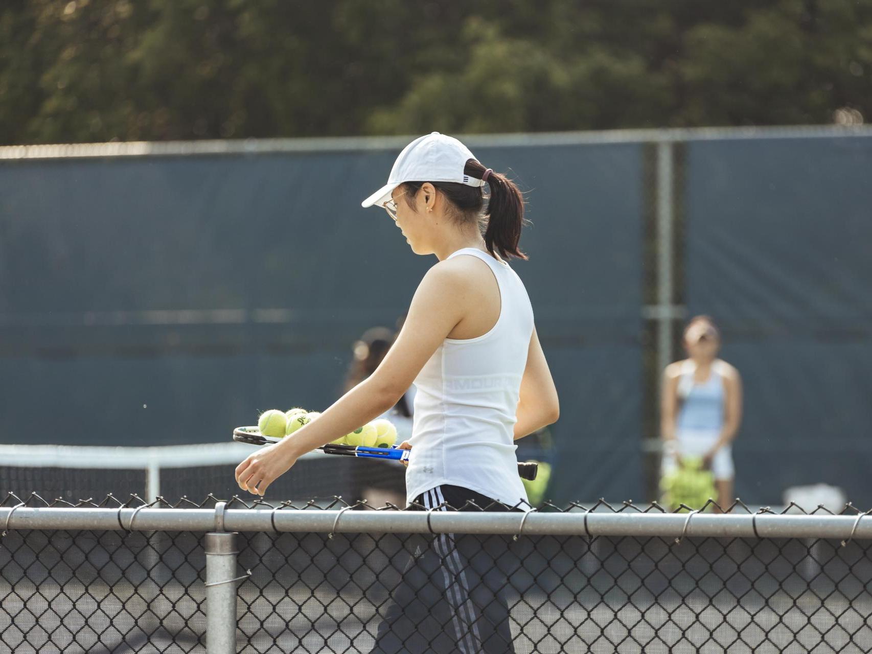 student playing tennis.