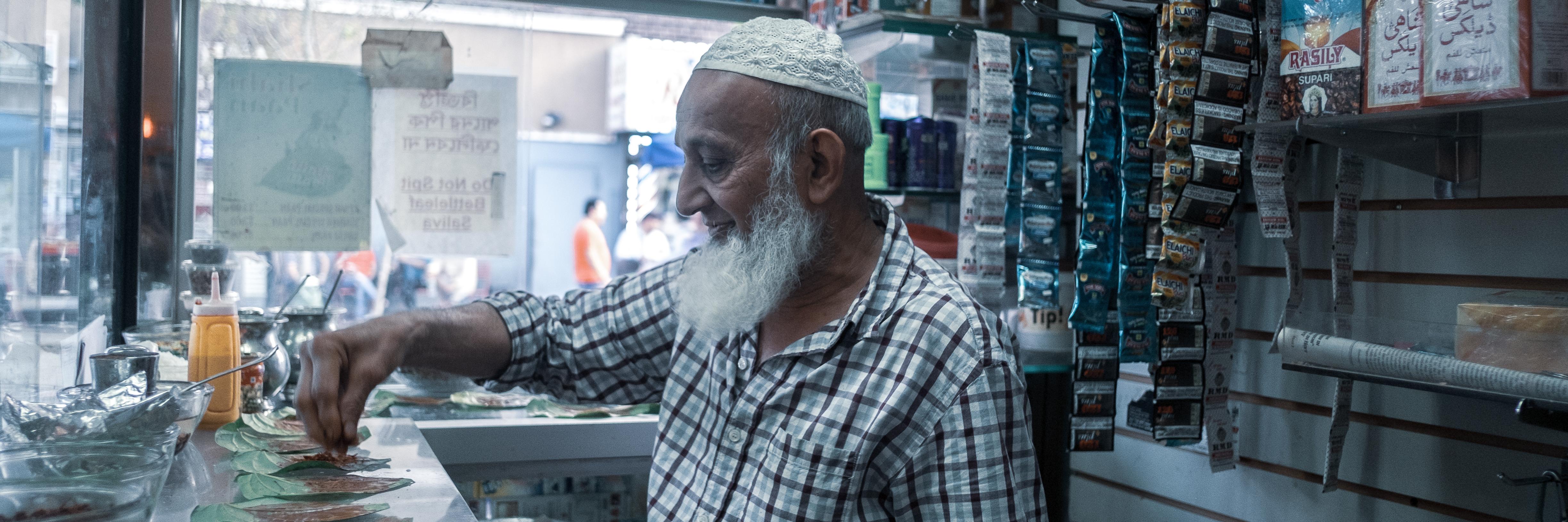 man preparing betel in small shop in New York City