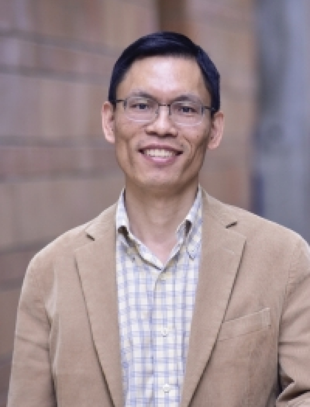 Photo of Prof Li Chen in a beige suit