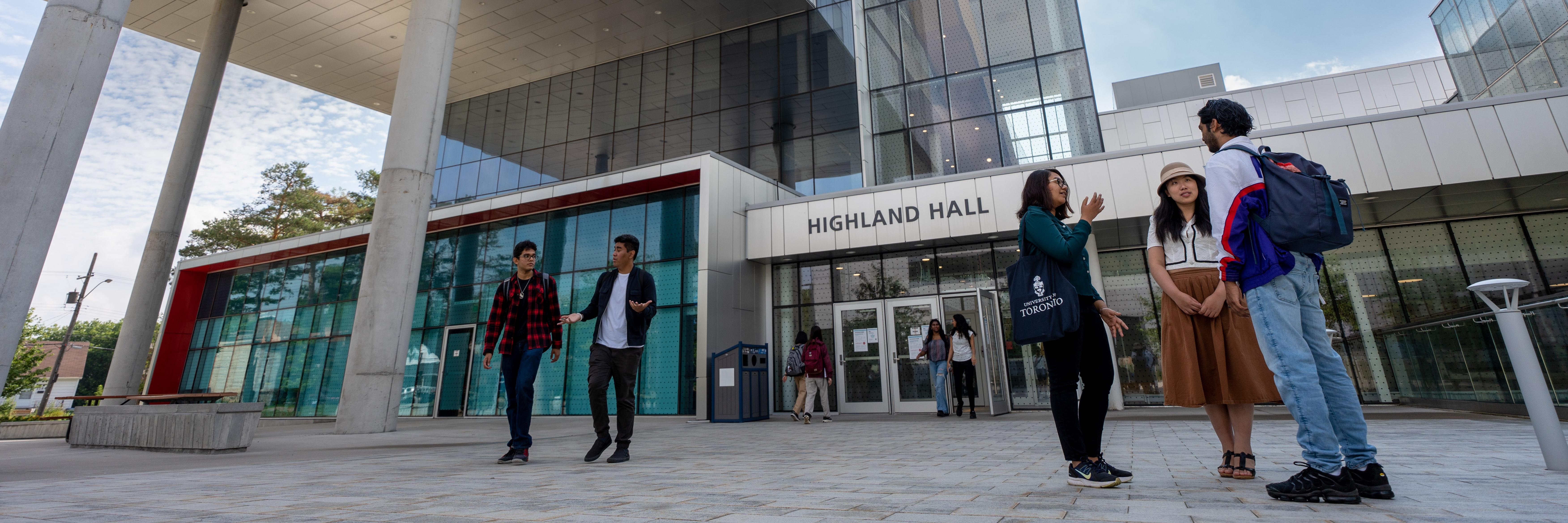 Students standing outdoors in front of Highland Hall