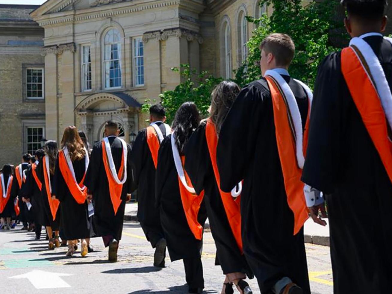 Management graduates line up as they prepare to walk inside Convocation Hall