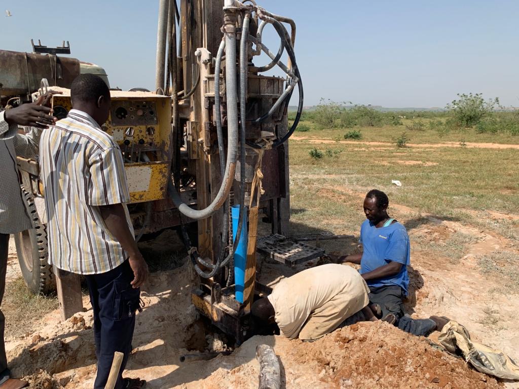 Locals building a well in Darfur, Sudan as part of the Wishing Well Company's work.