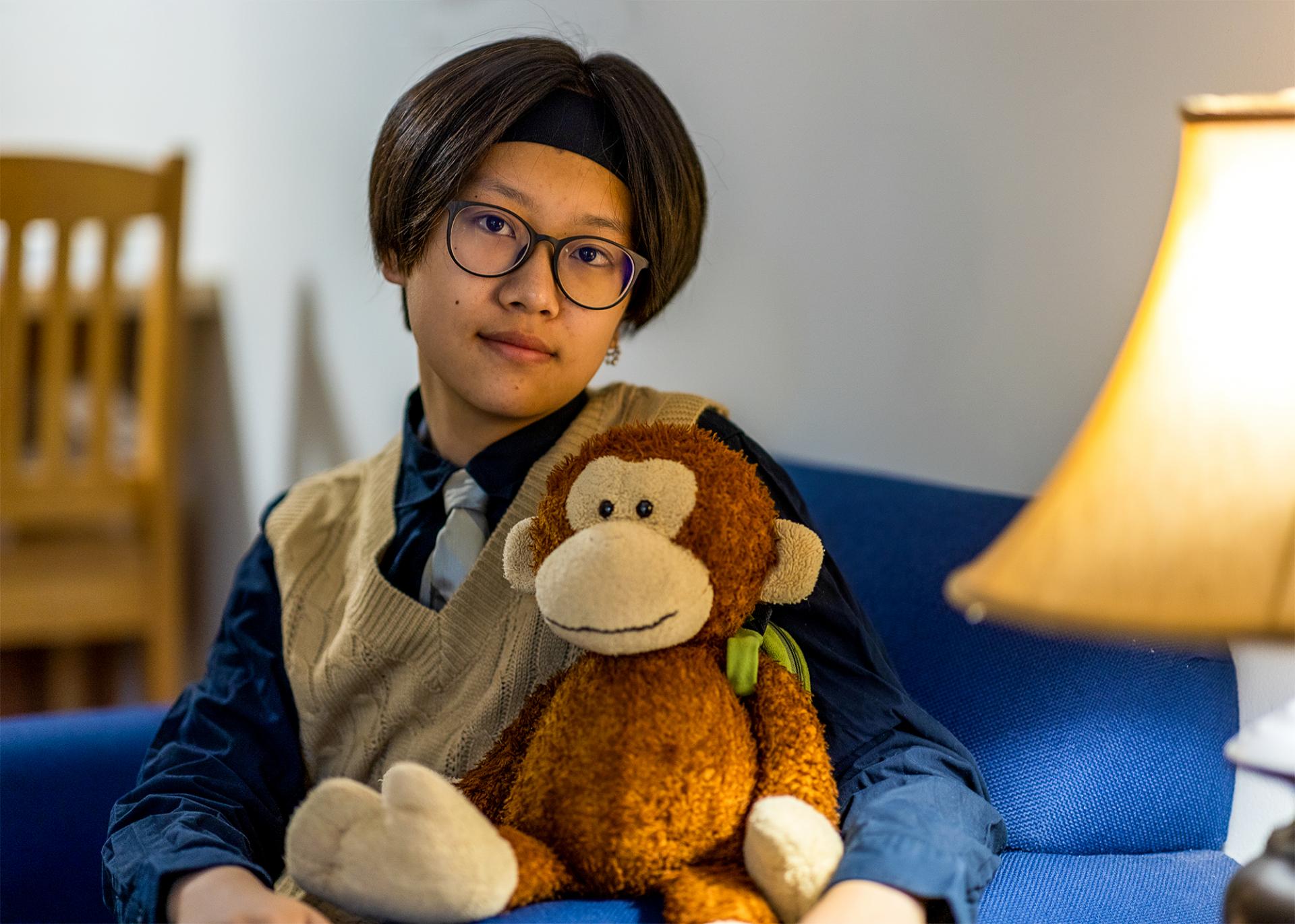 A photo of Cici Nie with a stuffed monkey