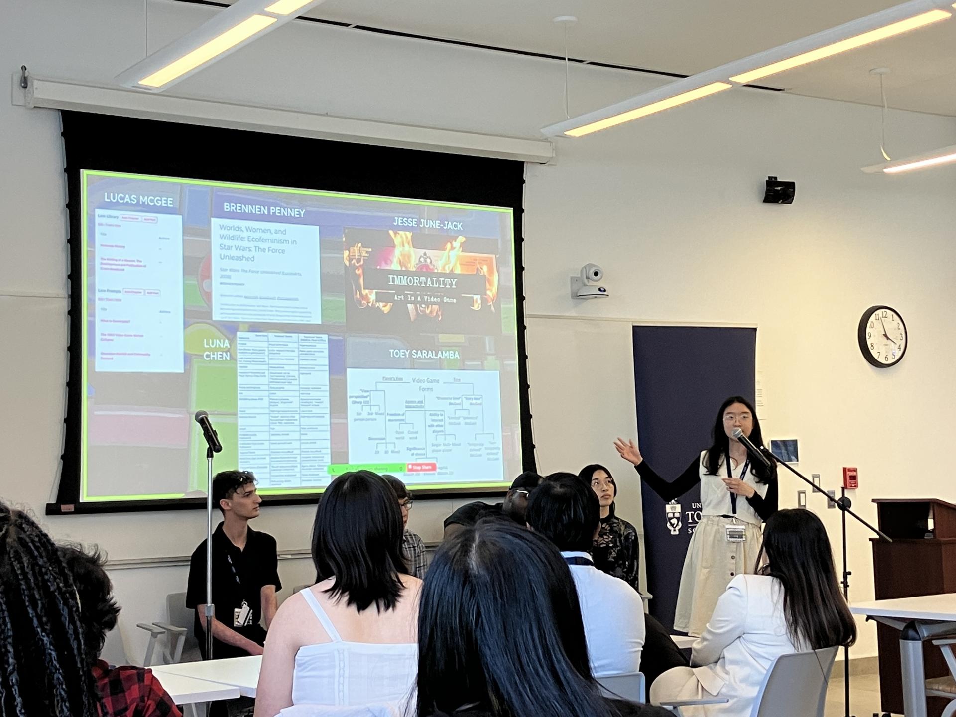 Student Toey Saralamba presenting a new resource for studying video games at a symposium.