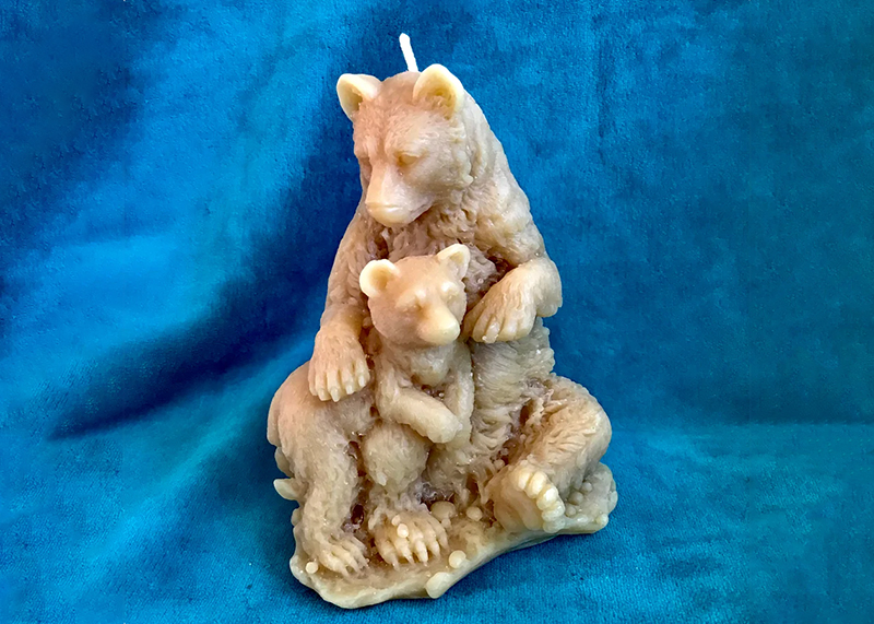 A sculpted bear and baby bear made of beeswax