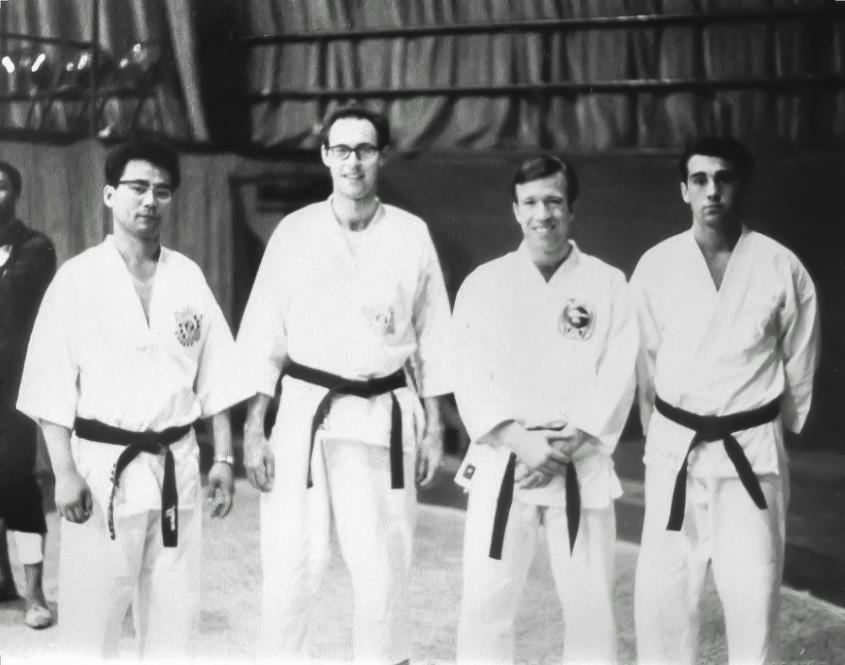 Four men in karate clothes. 