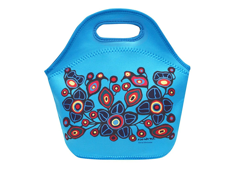 A bright blue lunch bag with a design featuring plants and birds
