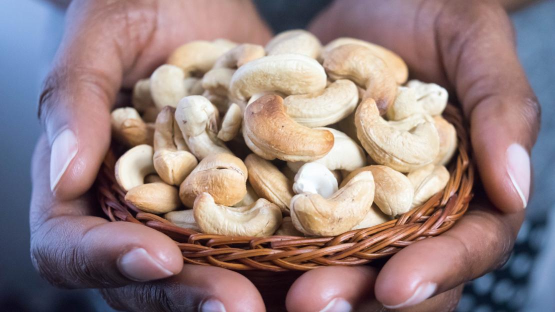 A person holding cashews