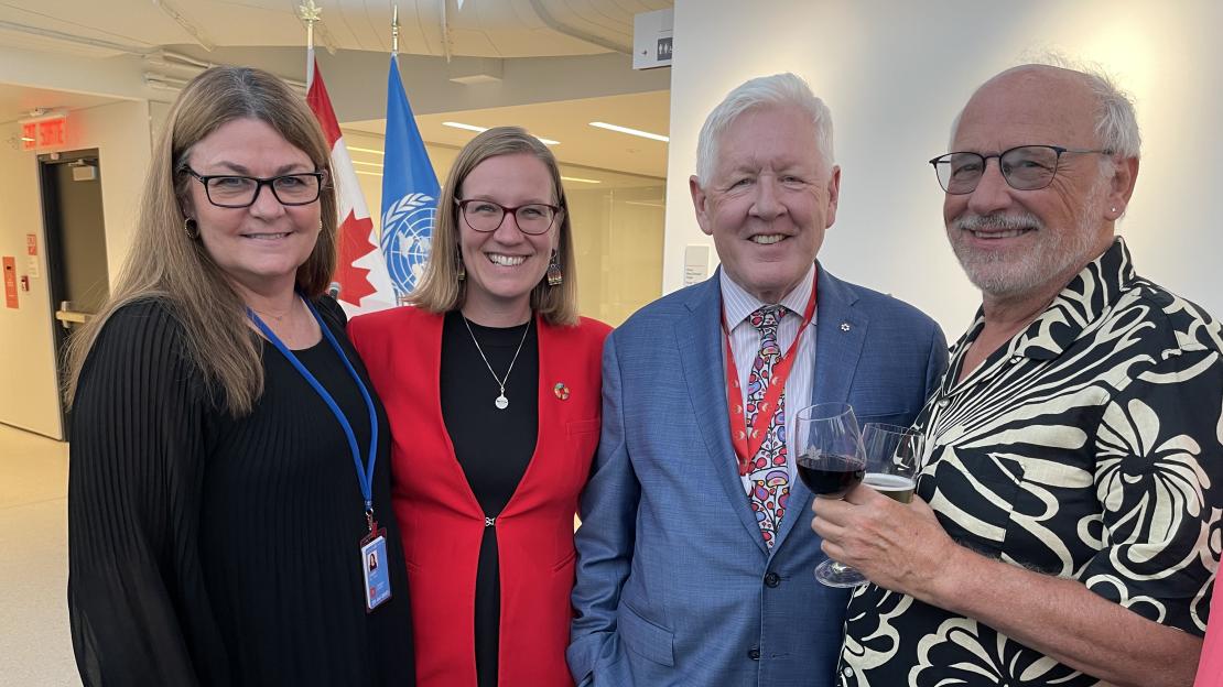 Irena Creed, Minister of Families, Children and Social Development of Canada and Head of the Canadian Delegation Karina Gould  And Bob Rae, Permanent Representative of Canada to the United Nations Bob Rae and Charles Trick in front of the Canadian and UN flags at UN headquarters. 