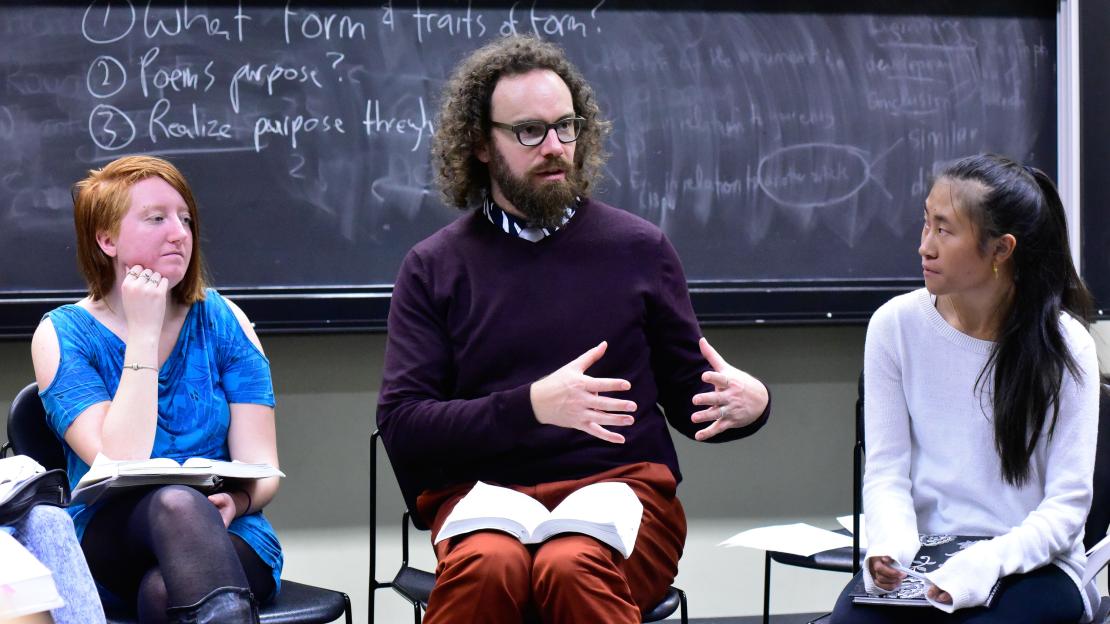 Professor Daniel Scott Tysdal sitting with two students
