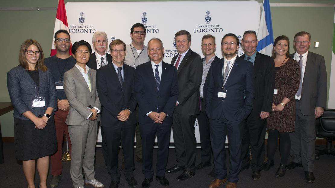 U of T President Meric Gertler poses with city manager Peter Wallace and Mayor John Tory, city councillors and city-focused faculty at the MOU signing event at City Hall (photo by Laura Pedersen)