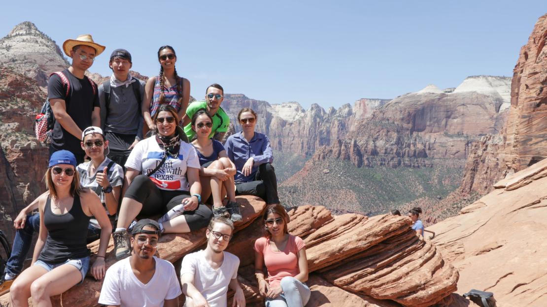 the students take a group photo by the Grand Canyon