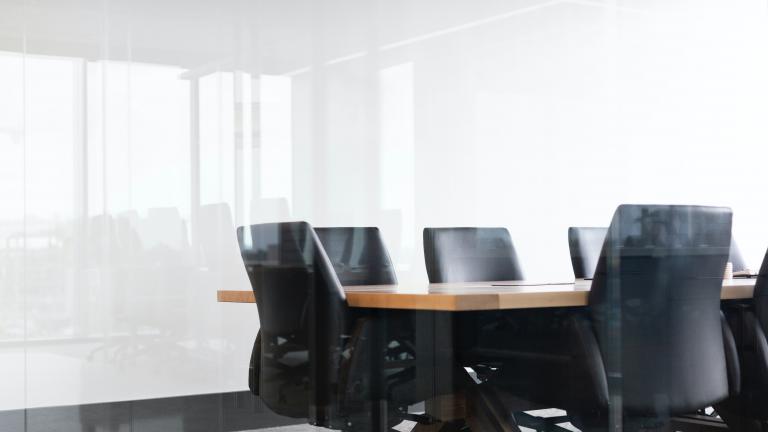 Empty chairs at a boardroom table
