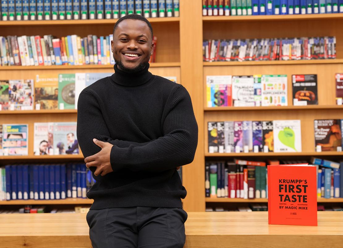 Michael Gayle at the UTSC Library beside his third book, Krumpp's First Taste