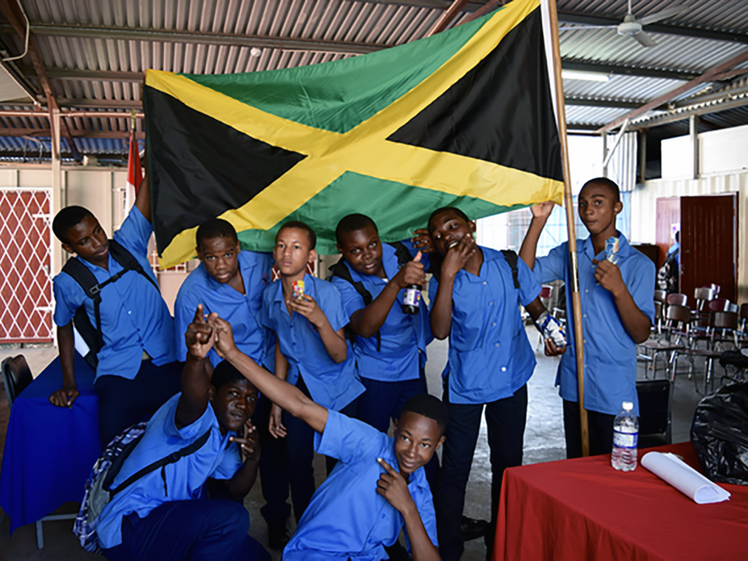 Jamaican students pose with the flag