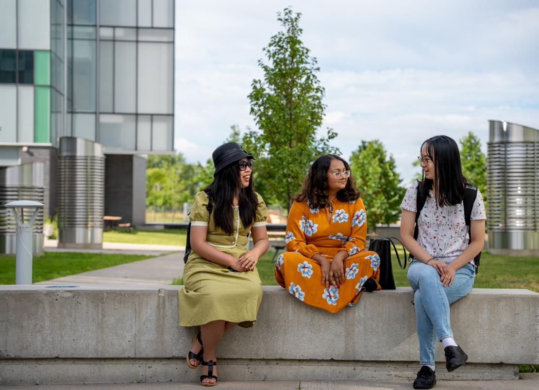 Three students in front of Environmental Science Building at U of T Scarborough
