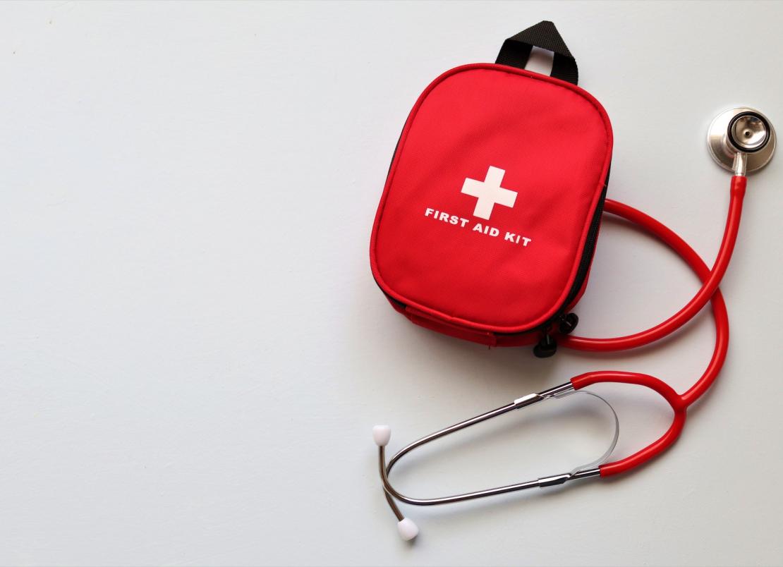 Red first aid kit and red stethoscope