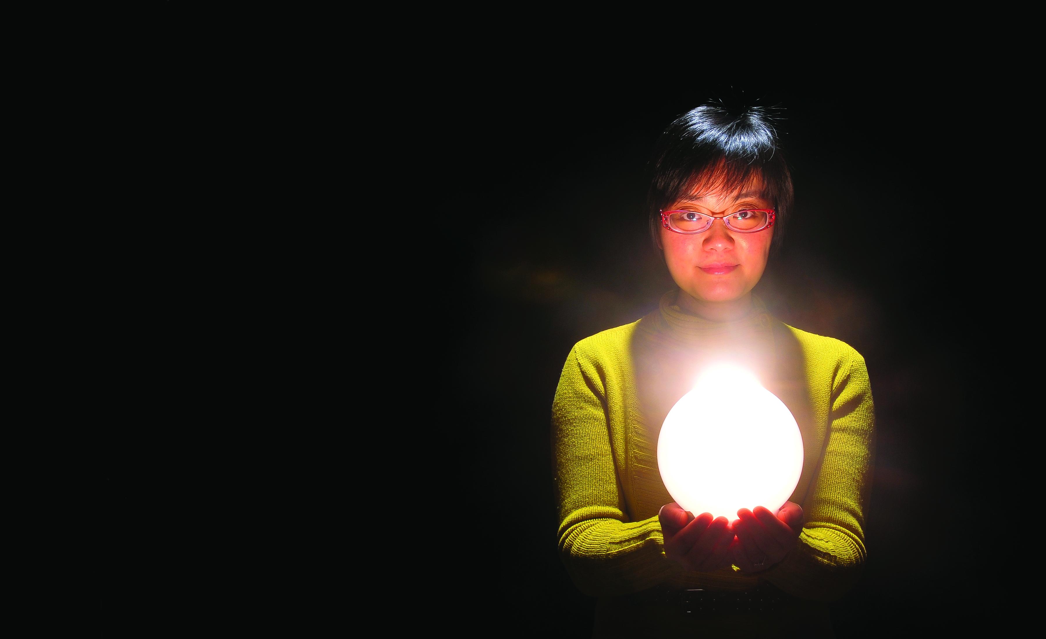 A woman holding a light.
