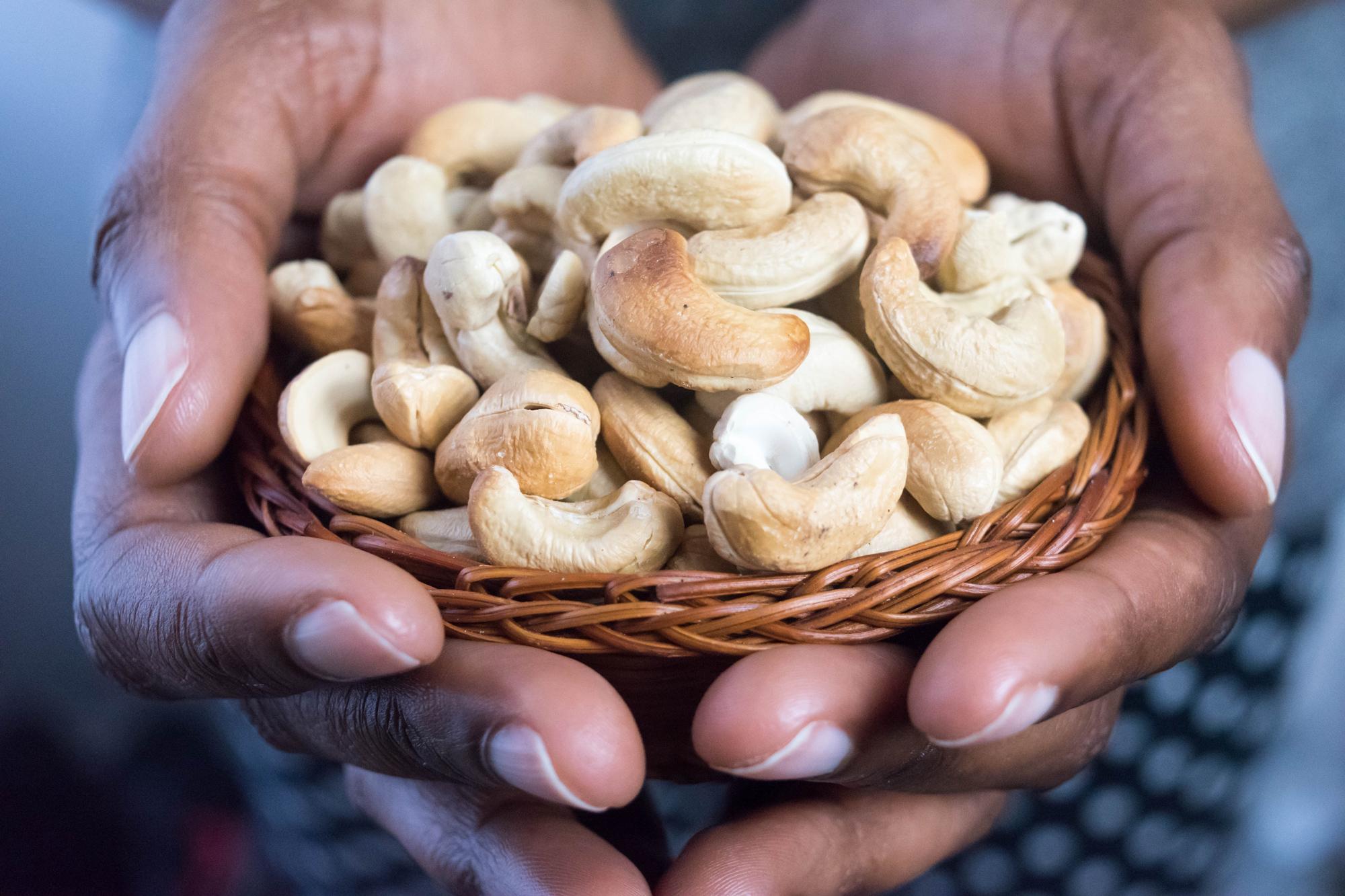 A person holding cashews