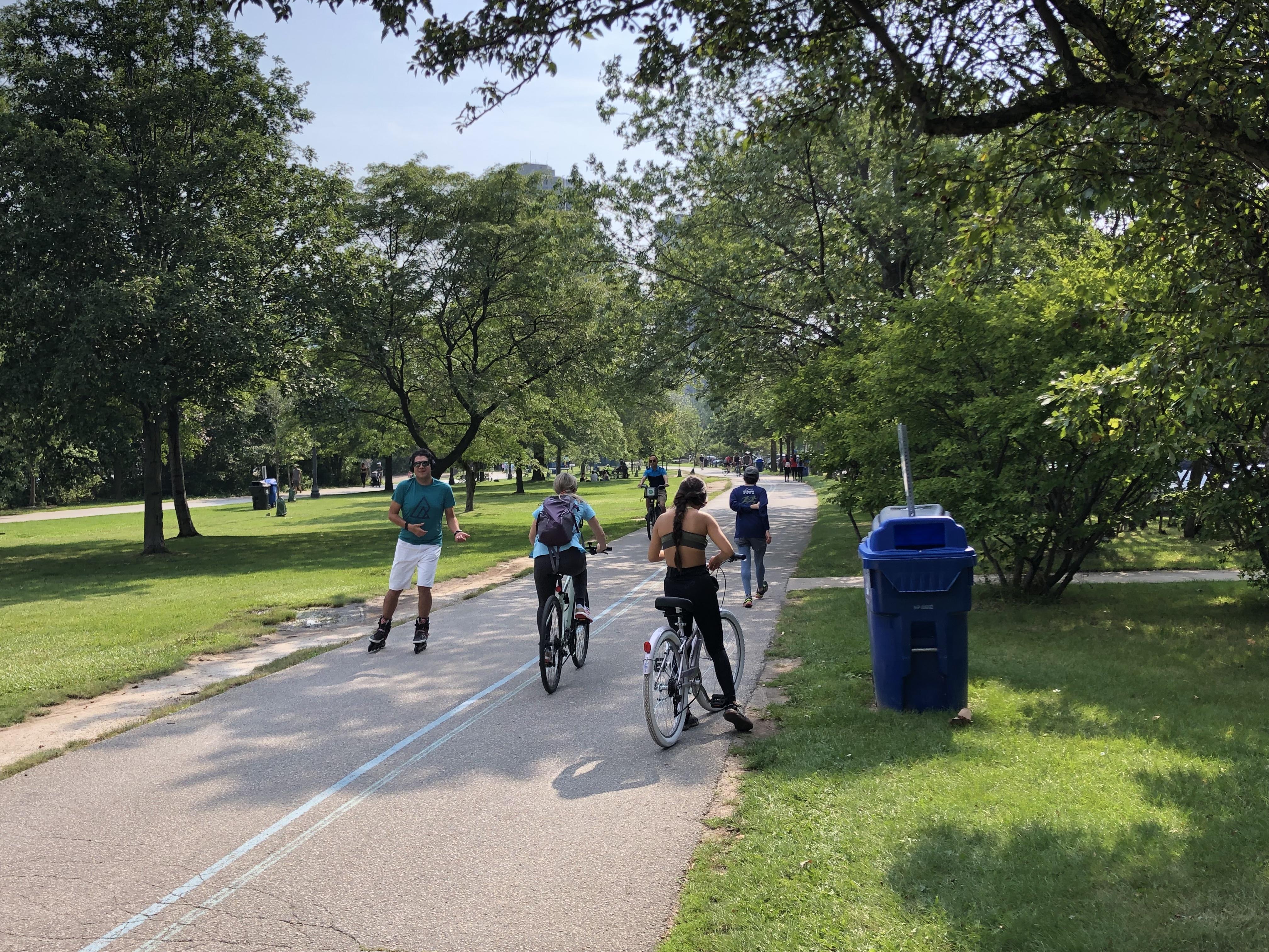 People biking, walking and roller blading on a public multi use path