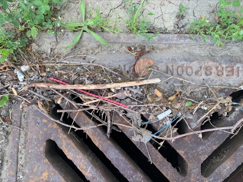 Sewer grate with plastic on top