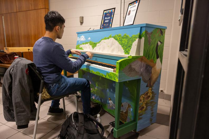 A photo of a student playing the piano