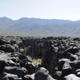 a photo of fossil falls - rock formations from lava