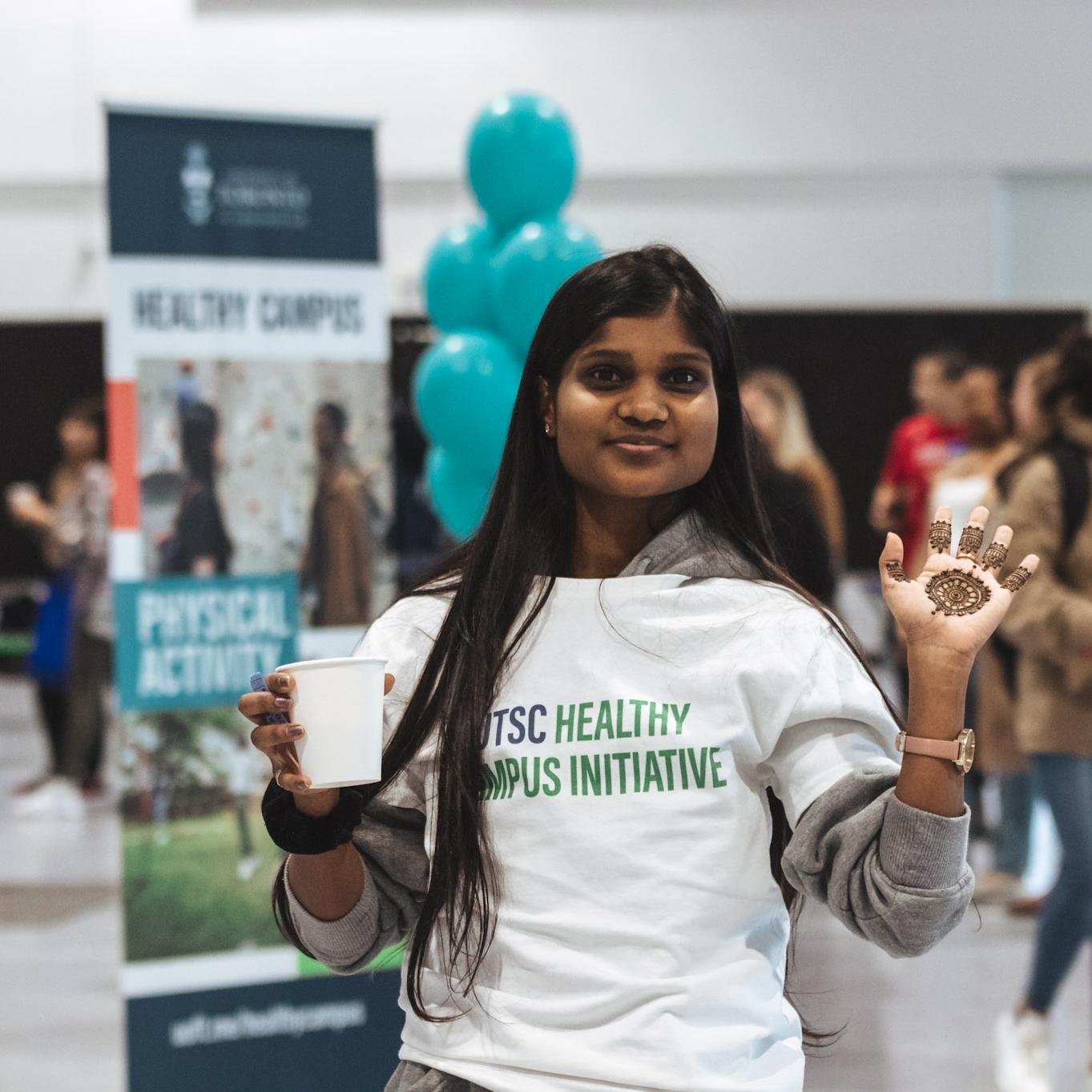 Student promoting health services at campus fair