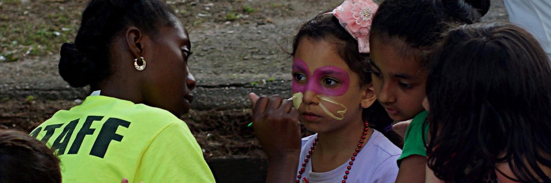 Child having their face painted