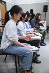 Attendees at SoundLife Scarborough learn about drumming in a hands-on session