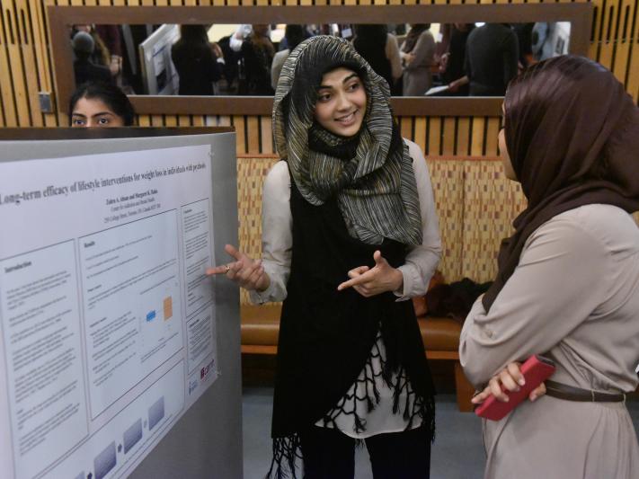 Student presenting an academic poster