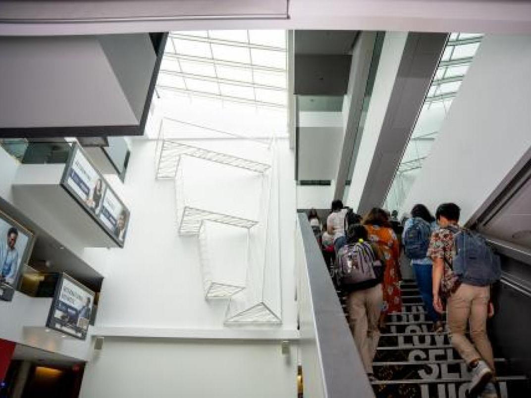 Students walking upstairs in IC Atrium