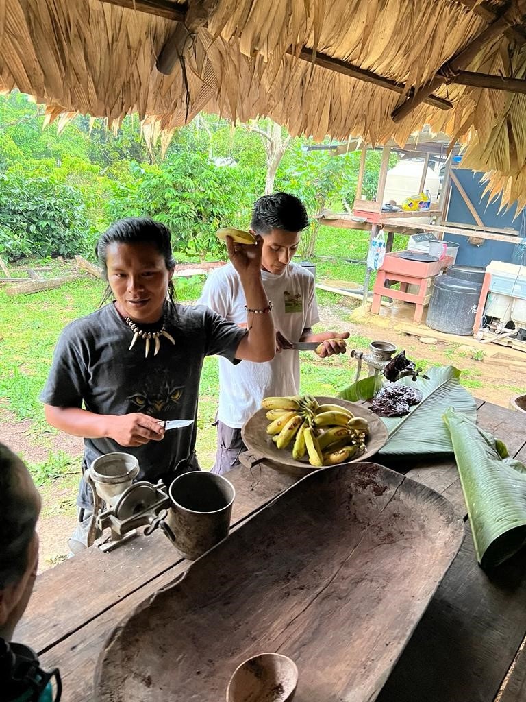 Mynor and Joel roasting the cacao seeds and serving up a delicious chocolate-banana treat using the cacao paste we made.