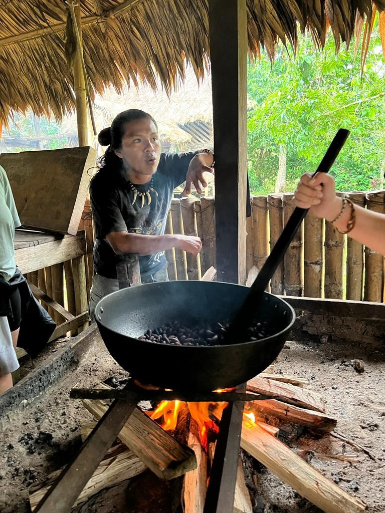 [Aiko House] Mynor and Joel roasting the cacao seeds and serving up a delicious chocolate-banana treat using the cacao paste we made.