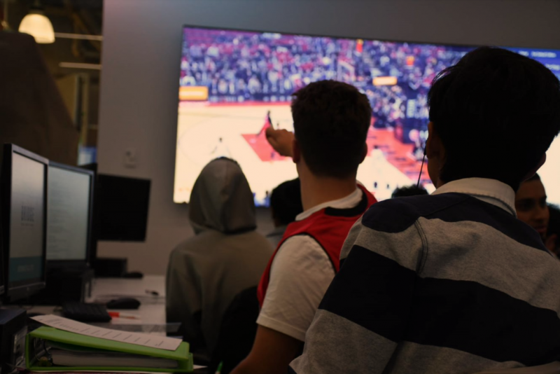 Students watching and analyzing Raptors game results