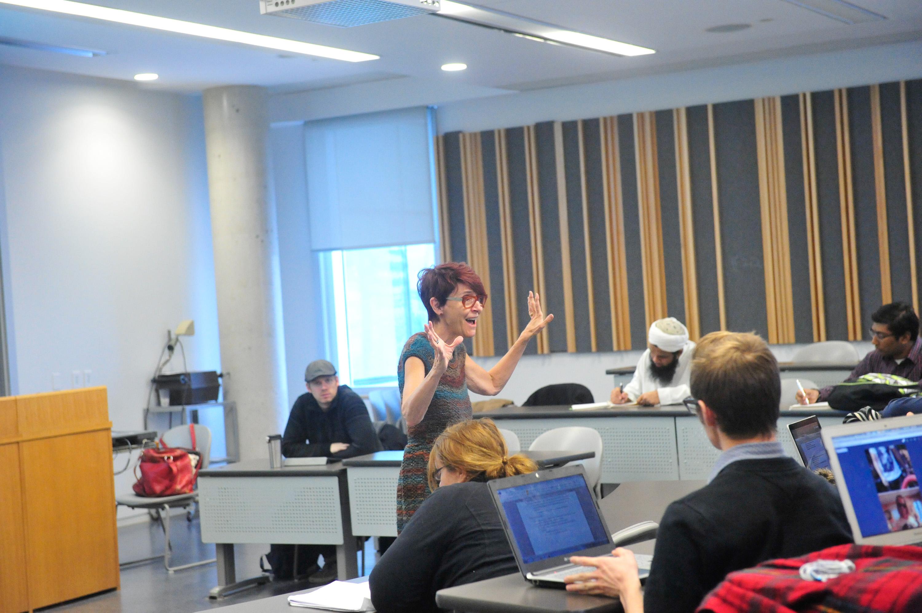 Professor Donna Gabaccia, very animated, lecturing to a class.